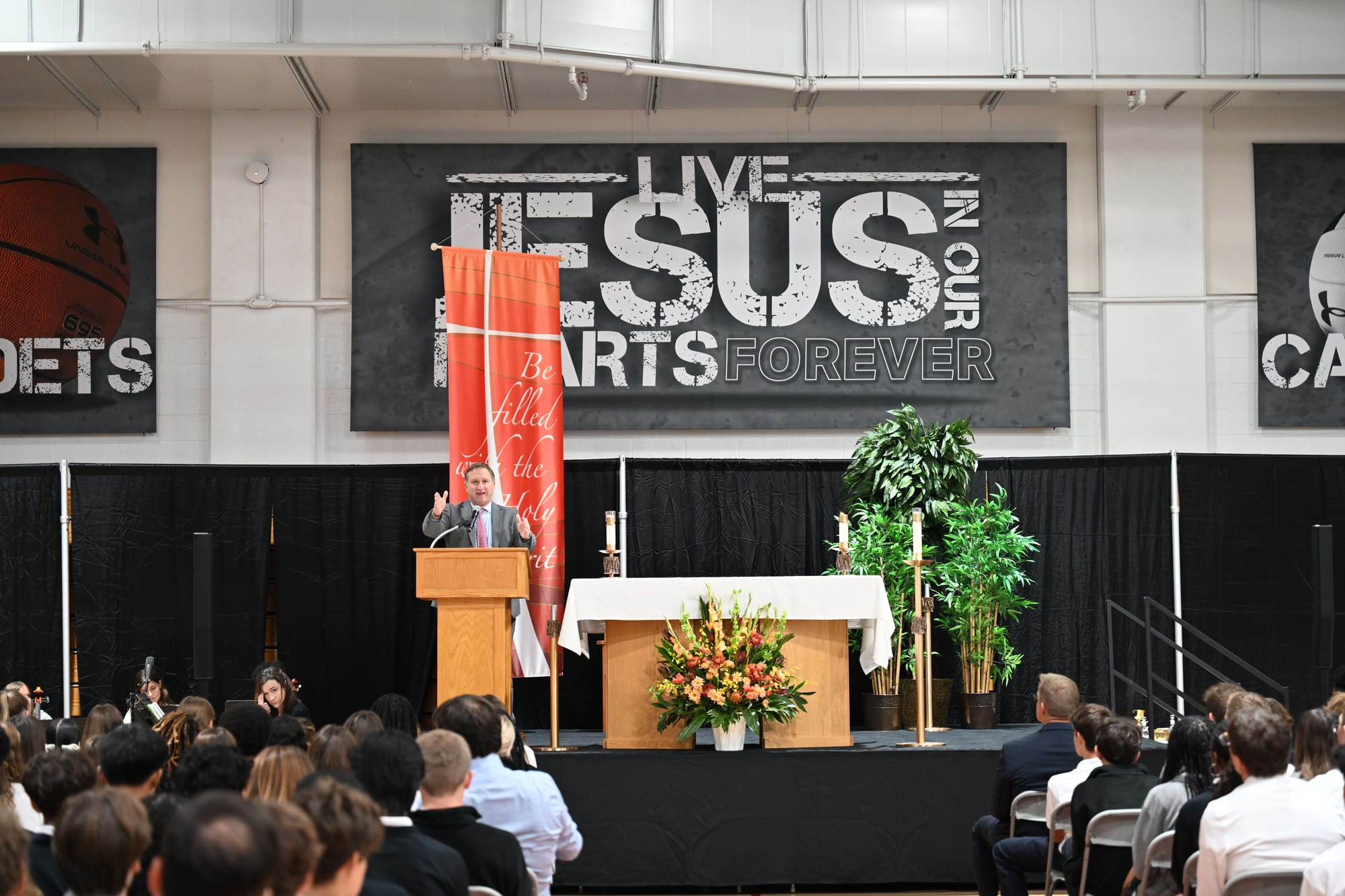 Dr. Themistos speaks in front of the student body